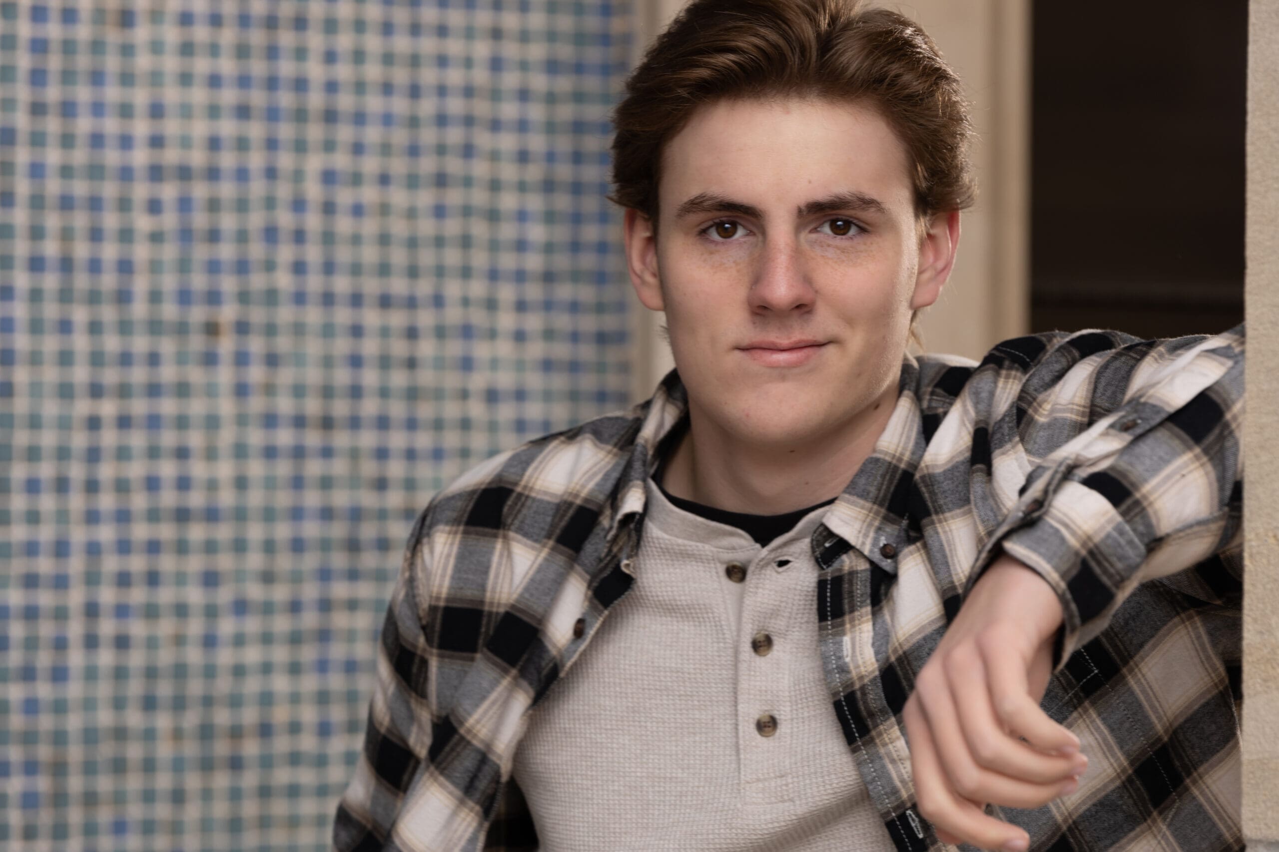 High school senior portrait at the War Memorial featuring architectural details and natural expression, photographed by Gallery Portraiture Kansas City.